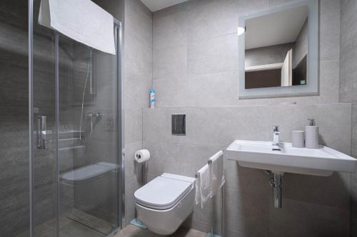 a bathroom with a toilet and a sink and a shower at Hillside Y34 in Dolný Kubín
