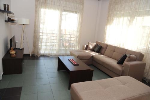 a living room with a couch and a coffee table at Kavala's central apartment in Kavála