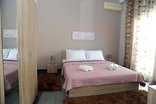 a bedroom with a bed with two towels on it at Kavala's central apartment in Kavála
