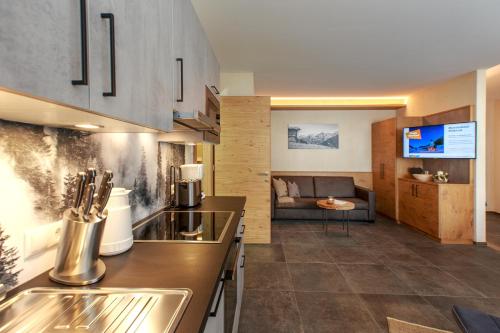 a kitchen and living room with a couch at Apart Lutz in Prutz