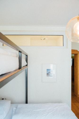 a bedroom with two bunk beds and a ceiling at Hostel Multitude in Leipzig