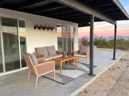 a patio with a couch and chairs and a table at Closest to Park Entrance, Stars, Private - WKNDR Starside in Twentynine Palms