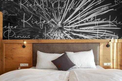 a bedroom with a chalkboard above a bed at Apart Lutz in Prutz