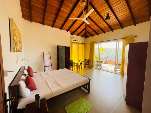 a bedroom with a bed and a ceiling fan at Feel Home in Kandy