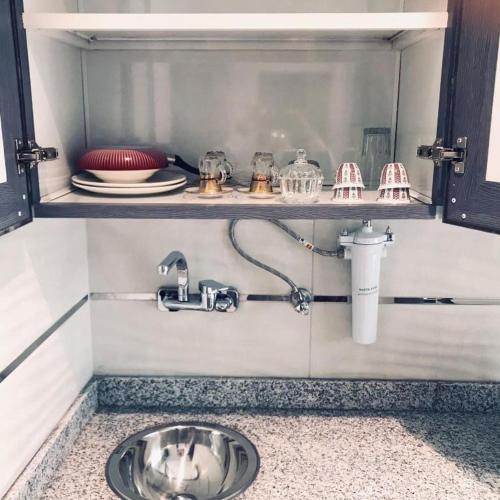 a kitchen counter with a sink in a kitchen at Atlantis International Hotel Apartments in Kuwait