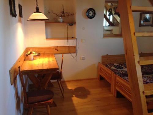 a room with a table and a bunk bed at Yveta - Depandance Horské Zátiší in Horni Misecky