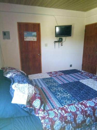 1 dormitorio con 1 cama y TV en la pared en Lynn's Peaceful Space en Willikies