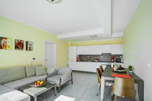 a living room with a couch and a table at Adria Lux Apartments Sveti Stefan in Budva