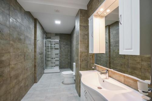 a bathroom with a sink and a toilet at Adria Lux Apartments Sveti Stefan in Budva