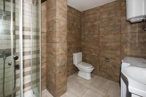 a bathroom with a toilet and a sink and a shower at Adria Lux Apartments Sveti Stefan in Budva