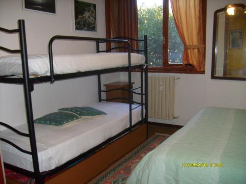 a room with two bunk beds and a window at House Yanina in Bellano