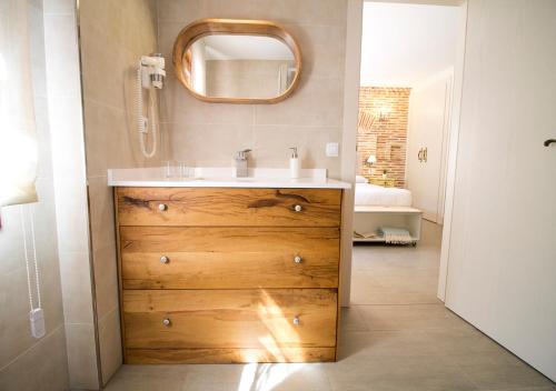 a bathroom with a sink and a mirror on the wall at El Patio de la Morera in El Rasillo