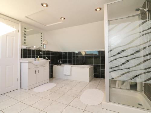 a bathroom with a sink and a shower at Surf View in Woolacombe