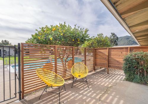 two yellow chairs sitting next to a fence at Contenta Inn in Carmel Valley