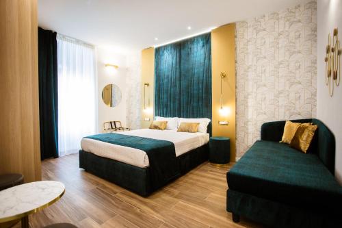 a hotel room with a bed and a couch at Design Suite Cinque Terre La Spezia in La Spezia