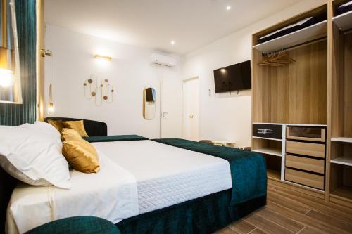 a bedroom with a large bed and a tv at Design Suite Cinque Terre La Spezia in La Spezia