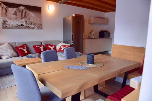 a kitchen and dining room with a wooden table and chairs at Ferienhaus Nockalmbahn in Bad Kleinkirchheim