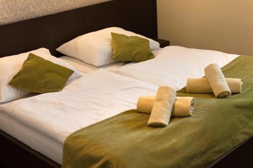a large bed with two pillows on it at Penzion Beryl in Košice