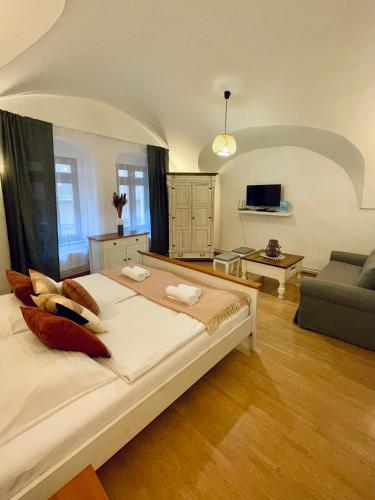 a bedroom with a large bed and a living room at Dorfel in Košice