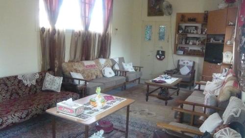 a living room with couches and chairs and a table at B&B at Palestinian home / Beit Sahour in Bethlehem