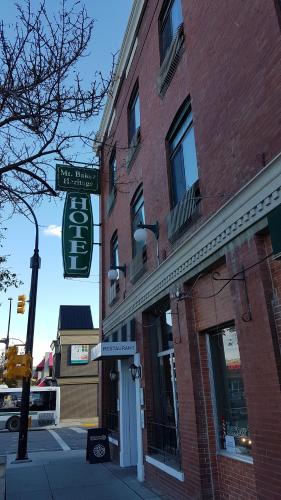 a brick building with a street sign in front of it at The Baker Hotel in Cranbrook