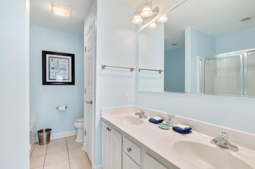 a white bathroom with a sink and a toilet at Turtle BAY 10 in Folly Beach