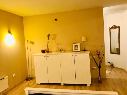 a room with yellow walls and a white cabinet at VNVP Black Amber in Štip