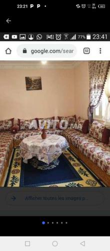 a living room with a couch and a table at Maison de vacances zuine in Oujda