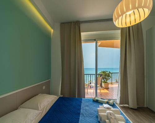a bedroom with a bed and a view of the ocean at Sicilian Charm in Marina di Ragusa