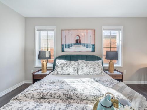 a bedroom with a bed and two windows at Boutique 3Br+Study Townhouse - Oakville in Oakville