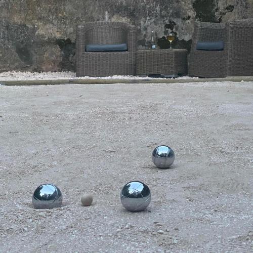 three balls are sitting in the middle of a parking lot at Casa Holstein Quinta de Sao Sebastiao Sintra in Sintra
