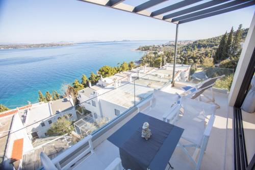 a view of the ocean from the balcony of a house at Raise Spetses Sea View Villa in Spetses