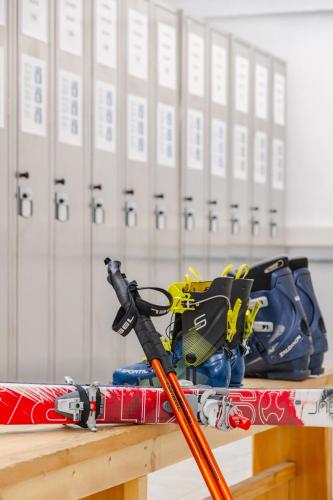 a pile of ski equipment sitting on a table at Hotel Ramon in Campitello di Fassa