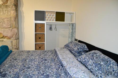 a bedroom with a bed with pillows and a closet at Hebble end works apartment 3 in Hebden Bridge