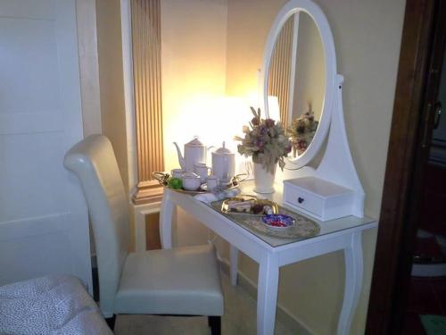 a white vanity with a mirror and a sink at B&B VILLA BELLA in Catanzaro