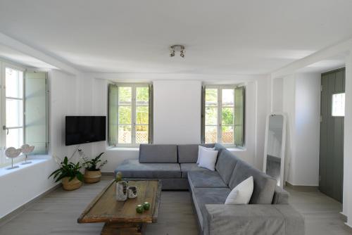 a living room with a couch and a table at FAMILY in Spetses