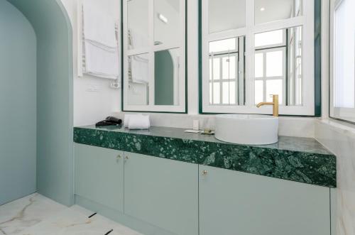 a bathroom with a sink and two mirrors at Westlight Cascais Chalet - Adults Only in Cascais