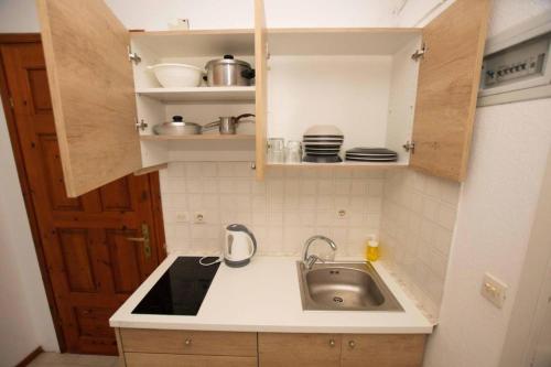 a small kitchen with a sink and a counter at Katerina's Garden Mola Kaliva in Mola Kalyva