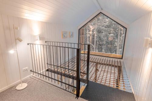 an attic room with a staircase with a window at Leśna Kąpiel in Karpacz