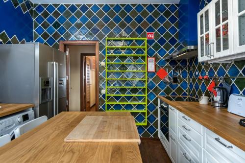 a kitchen with a wooden table and a blue wall at Holiday villa in elite residential area of Faro in Faro