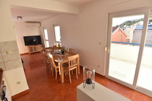 a kitchen and dining room with a table and chairs at Holiday Home in Komarna