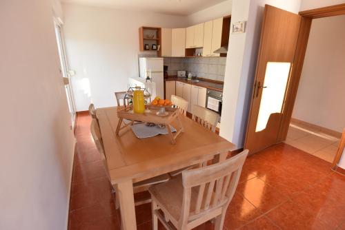 a small kitchen with a wooden table and chairs at Holiday Home in Komarna
