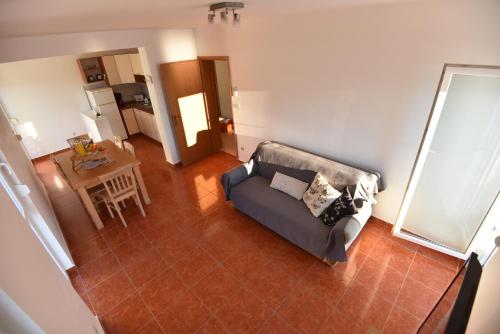 a living room with a couch and a table at Holiday Home in Komarna