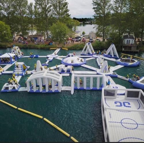 a bunch of inflatable water slides in the water at The Sunflower Luxury caravan at Tattersall lakes in Tattershall