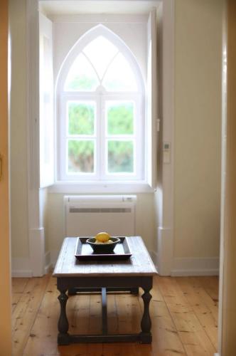 a room with a table in front of a window at Casa Holstein Quinta de Sao Sebastiao Sintra in Sintra