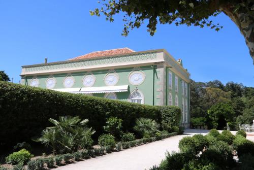 a building with clocks on the side of it at Casa Holstein Quinta de Sao Sebastiao Sintra in Sintra