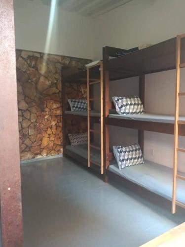a room with four bunk beds with pillows on them at Recanto da Iara in Arraial do Cabo