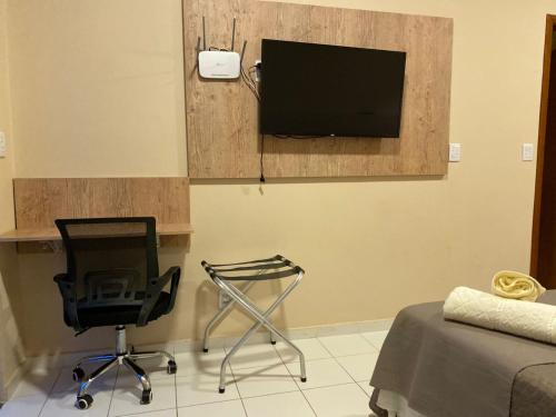 TV a/nebo společenská místnost v ubytování Studio em Caxambu
