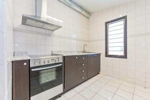 a kitchen with a stove and a sink at King Hotel in Palmerston