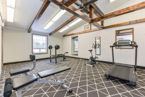 a gym with exercise equipment in a room with beams at King Hotel in Palmerston